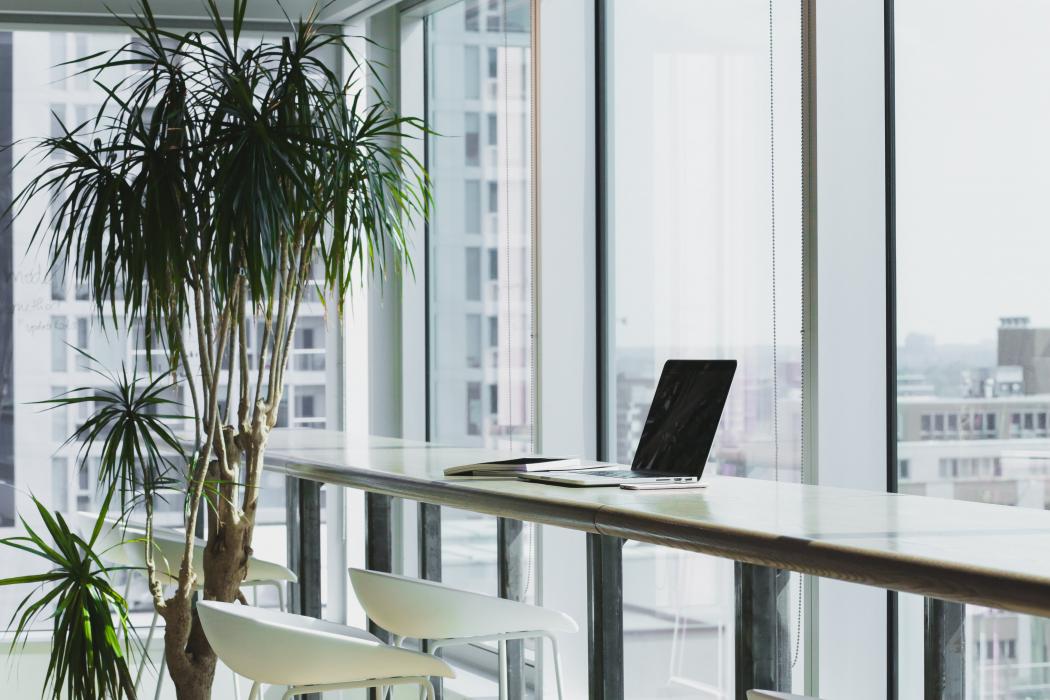 Desk at window in build with laptop on desk