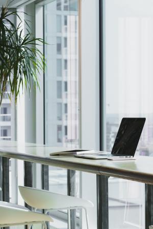 Desk at window in build with laptop on desk