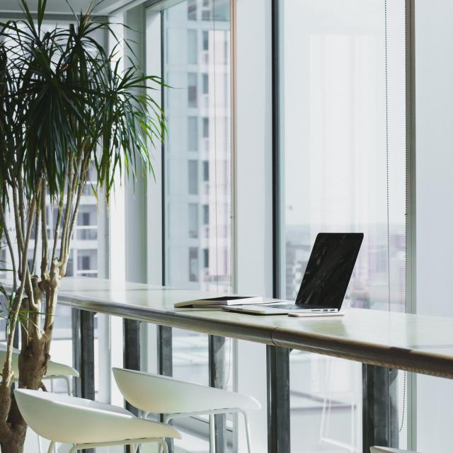 Desk at window in build with laptop on desk